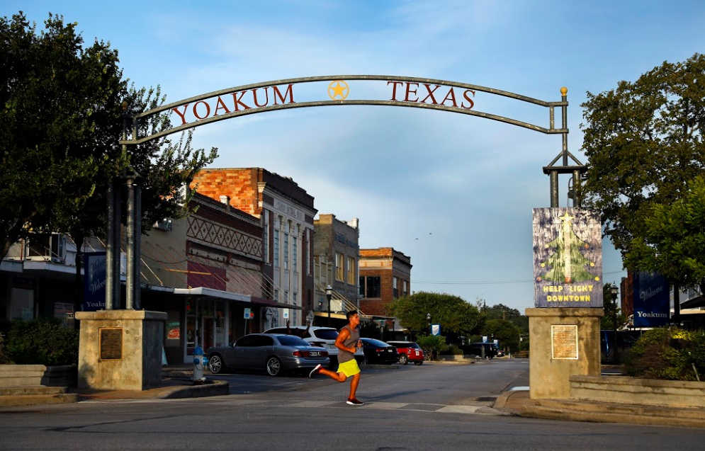 A runner travels under the gateway to downtown Yoakum, Texas.